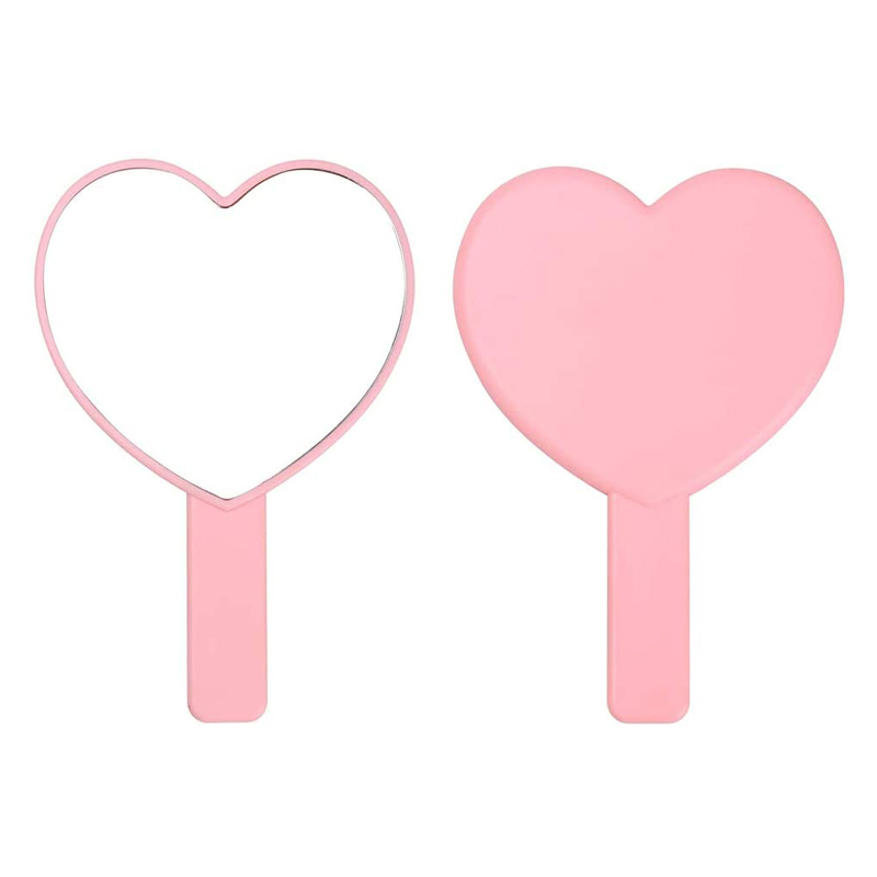 Herzförmiger dekorativer rosafarbener Handspiegel